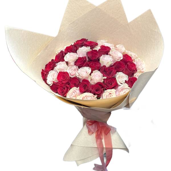 Bouquet of red and pale pink roses wrapped in beige paper