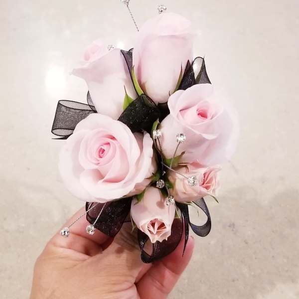 Small corsage with pale pink roses and black ribbon