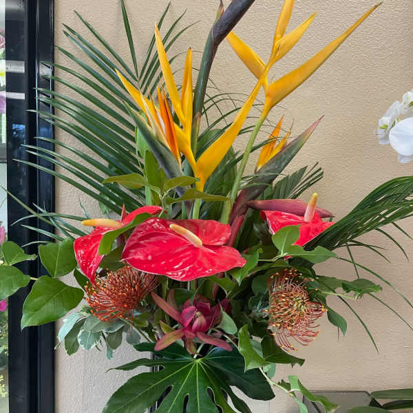 Tropical arrangement with red anthuriums and yellow bird of paradise