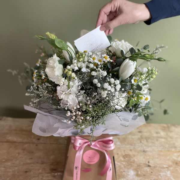 White mixed bouquet in a gift box with a pink ribbon
