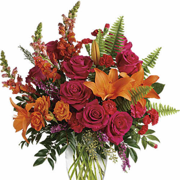Bouquet of orange lilies and pink roses in a clear glass vase
