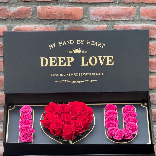 Black gift box with red and pink roses arranged as "I LOVE U"