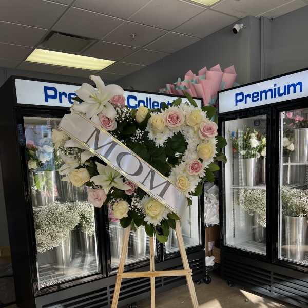 Heart-shaped floral wreath on an easel with a MOM sash