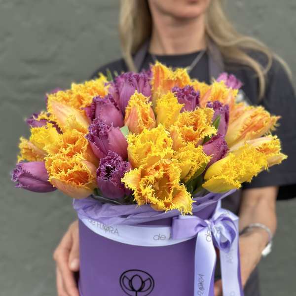 Bouquet of purple and yellow fringed tulips in a lavender hat box