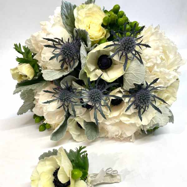 Cream bouquet with blue thistle and a matching boutonniere