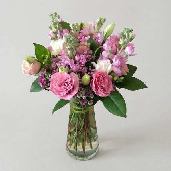 Pink and white bouquet in a clear glass vase