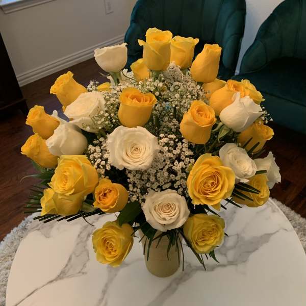 Bouquet of yellow and white roses in a vase