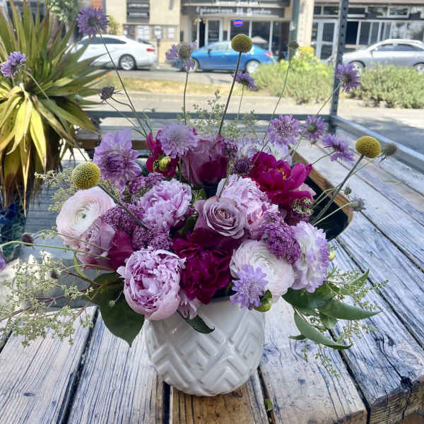 Pink and purple mixed bouquet in a white vase
