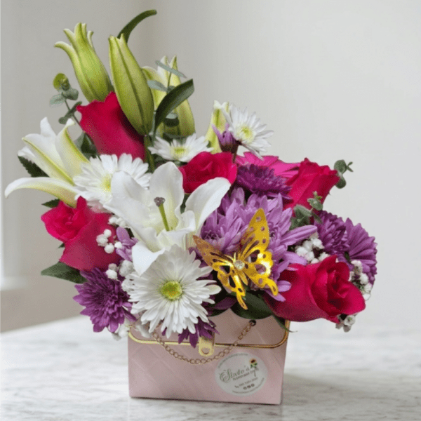 Bouquet of pink roses, white lilies, and purple daisies in a pink box