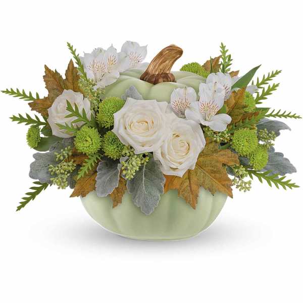 White roses and green mums in a pale green pumpkin vase