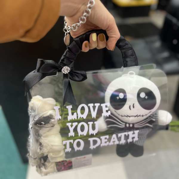 Clear gift bag with white roses and a Jack Skellington figure