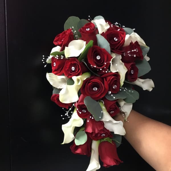 Bouquet of red roses and white calla lilies with eucalyptus accents
