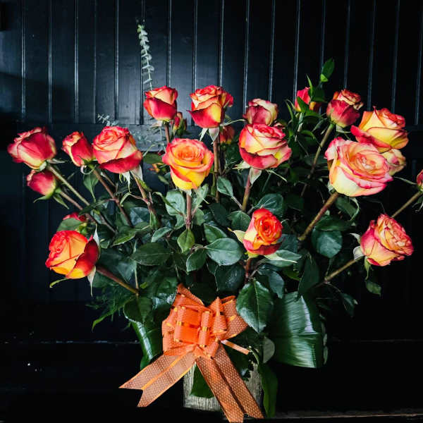 Bouquet of red and yellow roses with an orange ribbon