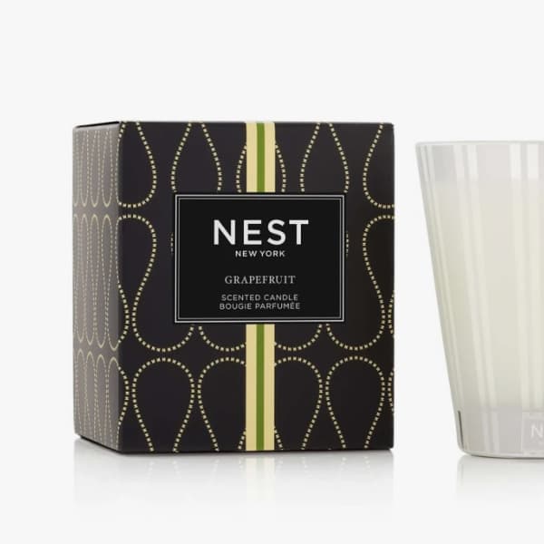 Scented candle in a frosted glass tumbler beside its box