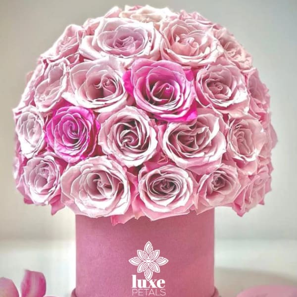 Pink rose bouquet in a round pink box with a ribbon