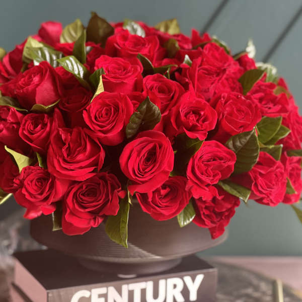 Large bouquet of red roses in a dark vase
