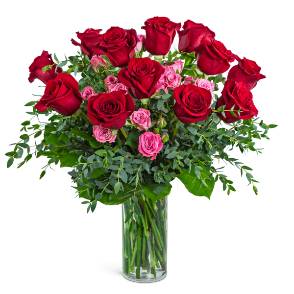 Red and pink roses in a clear glass vase
