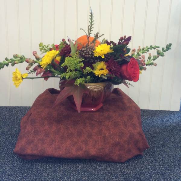 Mixed bouquet in a glass vase with yellow and red flowers