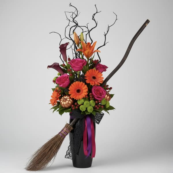 Halloween floral arrangement with orange and pink flowers in a black vase