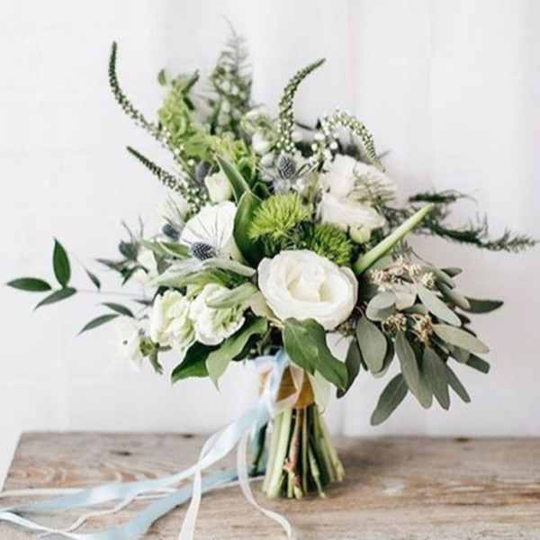 White and green bouquet with ribbon tied stems