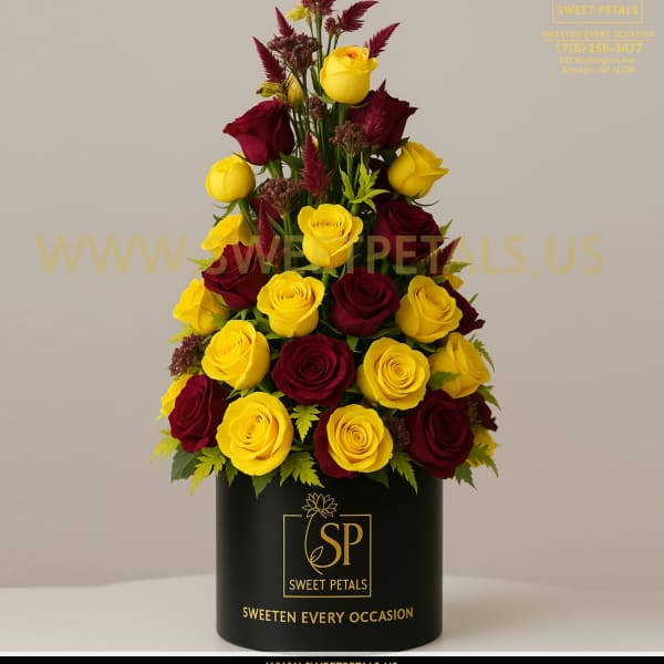 Tall arrangement of yellow and burgundy roses in a black box