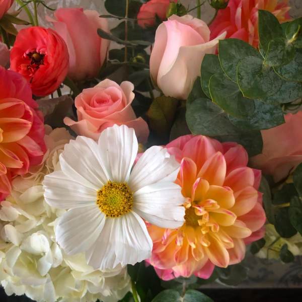 Mixed bouquet with pink roses, white daisies, and peach dahlias