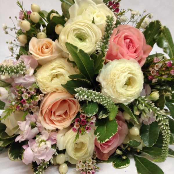 Bouquet of pink and cream roses with white ranunculus