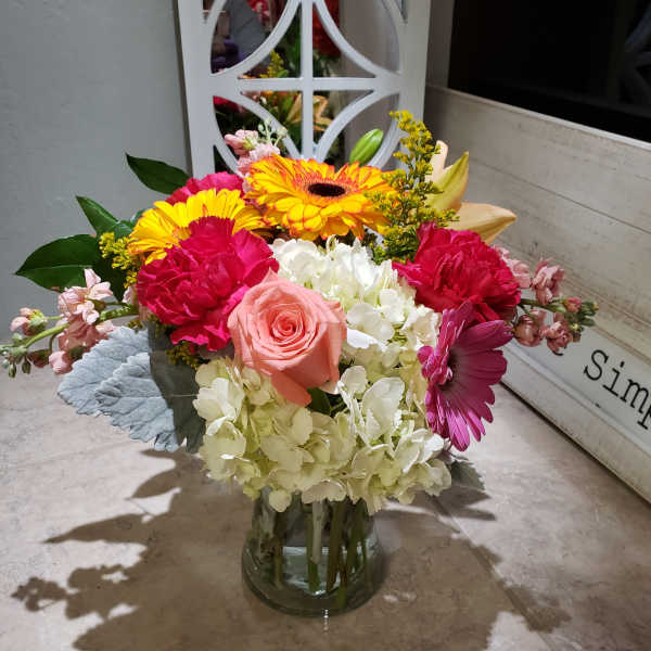 Colorful mixed bouquet in a clear glass vase