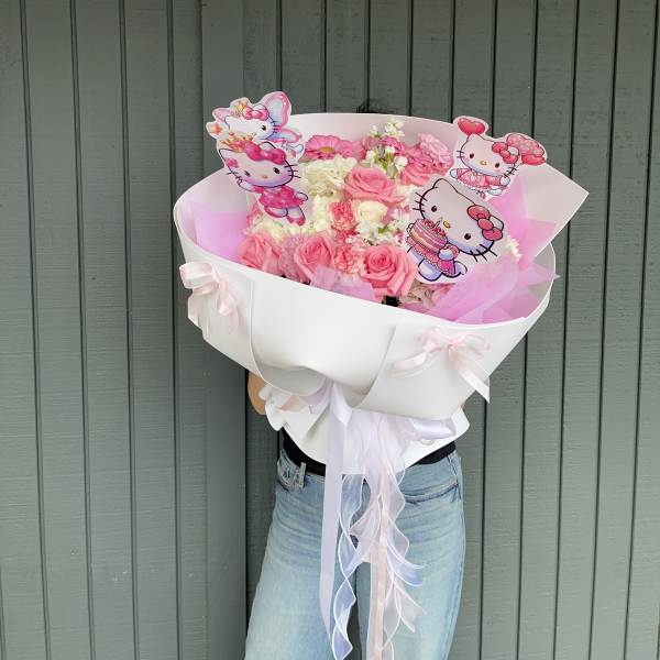Pink and white bouquet with Hello Kitty toppers in a white wrap