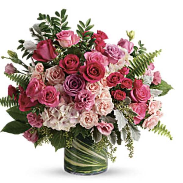 Pink and lavender rose bouquet in a glass vase