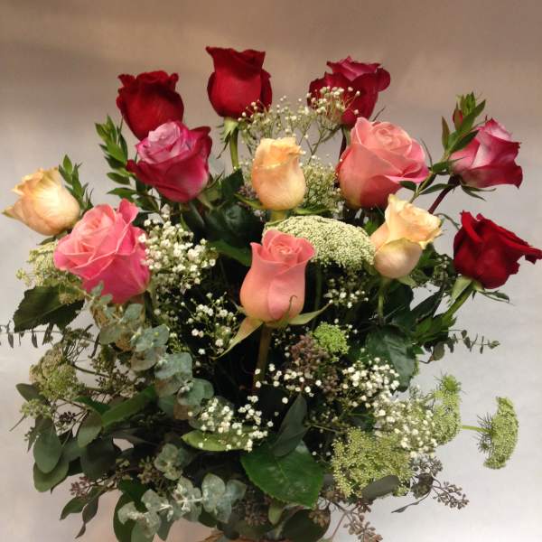 Bouquet of red and pink roses in a glass vase