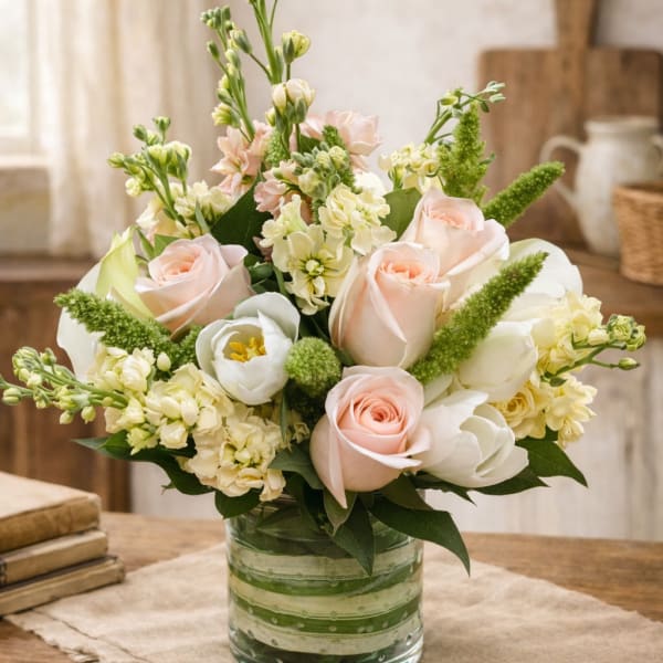 Bouquet of pale pink and white flowers in a glass vase