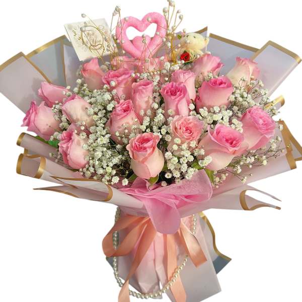 Bouquet of pink roses with baby's breath and a pink heart topper