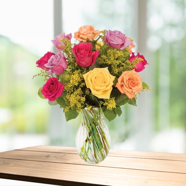 Mixed roses in a clear glass vase