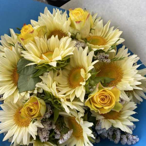 Bouquet of pale sunflowers and yellow roses