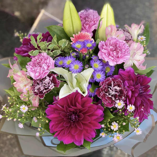 Bouquet of pink and purple flowers with white lilies