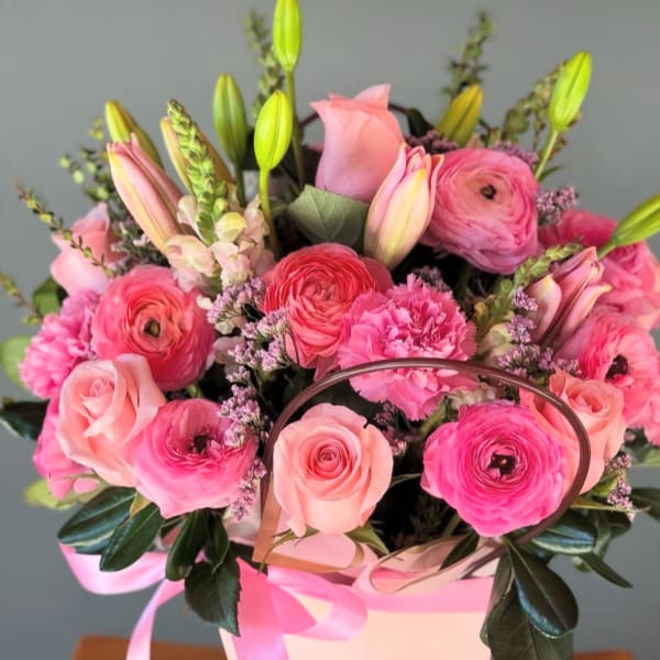 Pink mixed bouquet in a white gift box with a ribbon