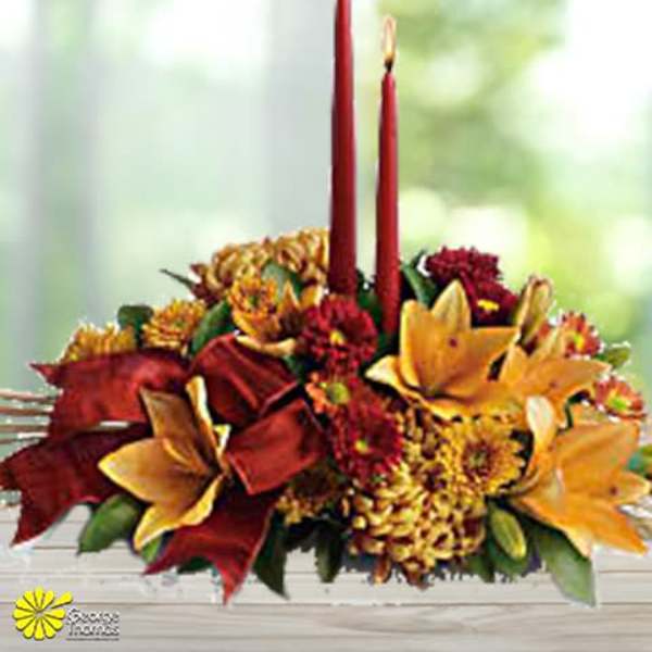 Autumn floral centerpiece with two red taper candles