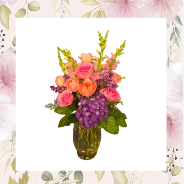 Pink and orange flowers arranged in a glass vase