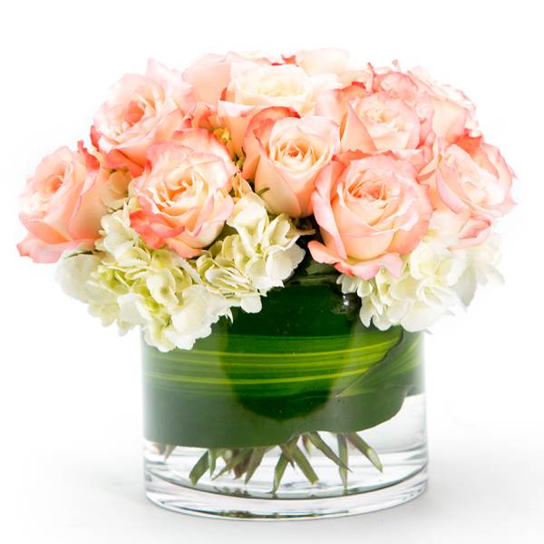 Pink roses and white hydrangeas in a glass vase