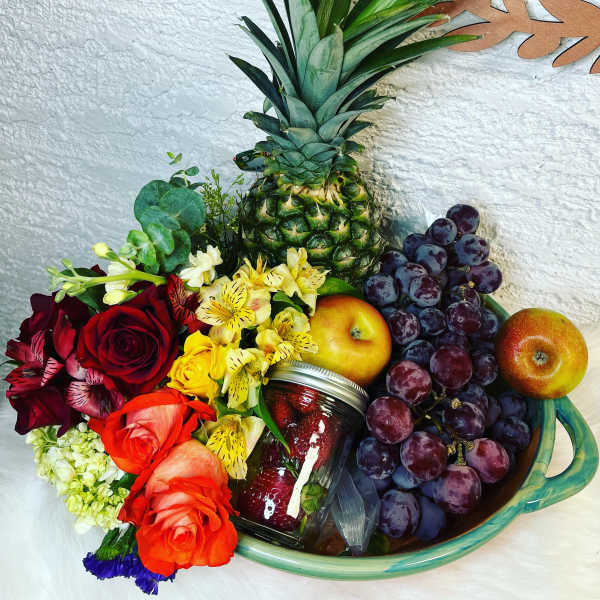 Fruit basket with roses, grapes, pineapple, apples, and a jar of strawberries