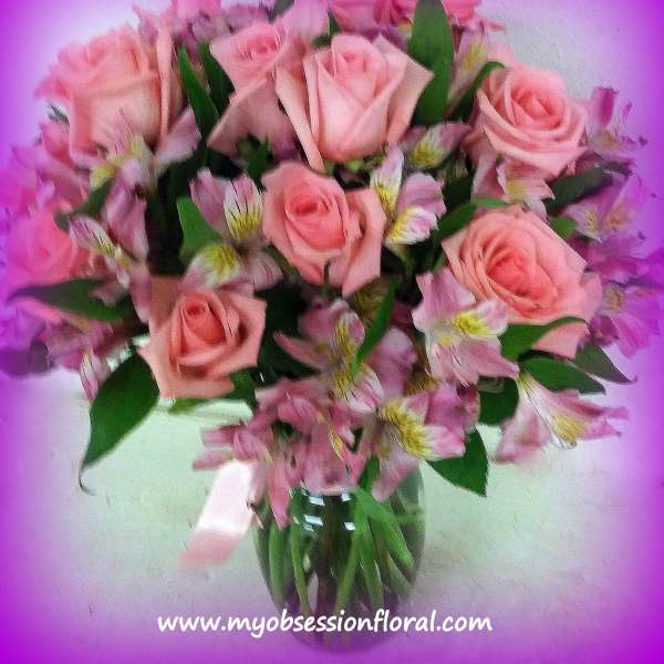 Pink roses and alstroemeria in a glass vase