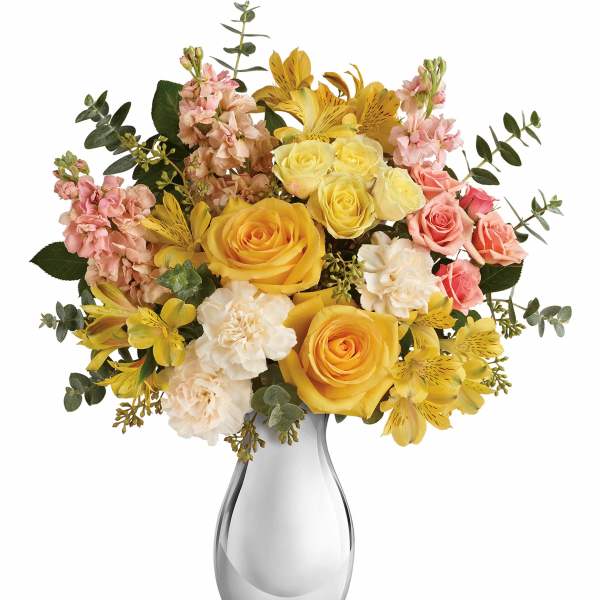 Yellow and pink flower bouquet in a clear glass vase