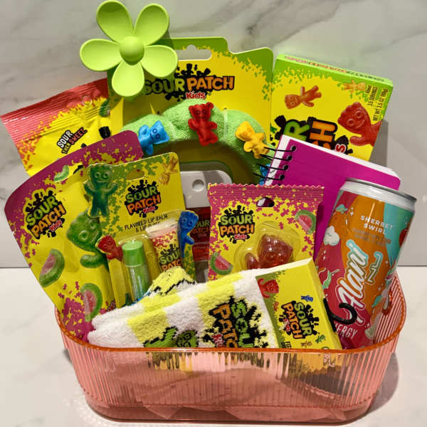 Gift basket with Sour Patch Kids candy, a can, and small accessories