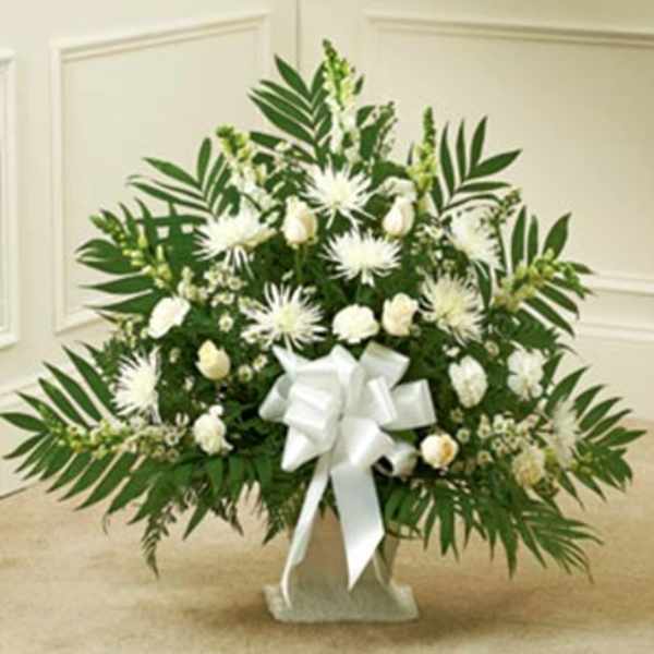 White floral standing spray with a large white bow