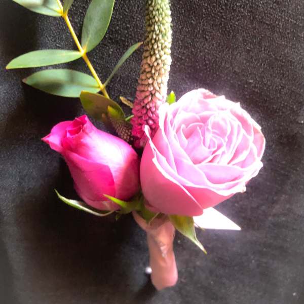 Pink rose boutonniere with eucalyptus and a tall green spike