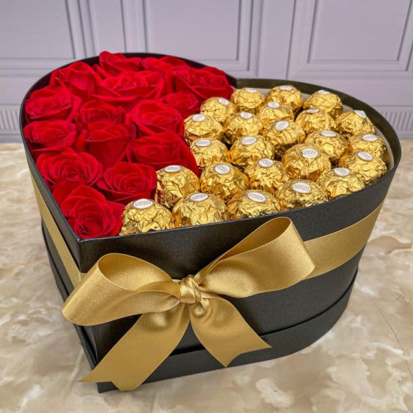 Heart-shaped box with red roses and gold-wrapped chocolates