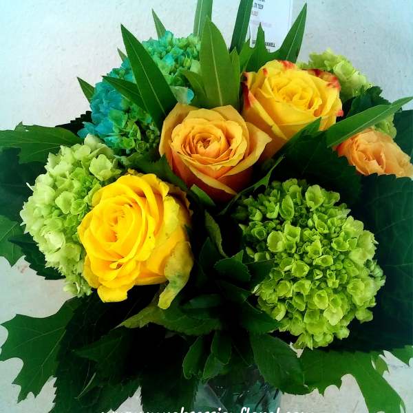 Bouquet of yellow roses and green hydrangeas in a vase