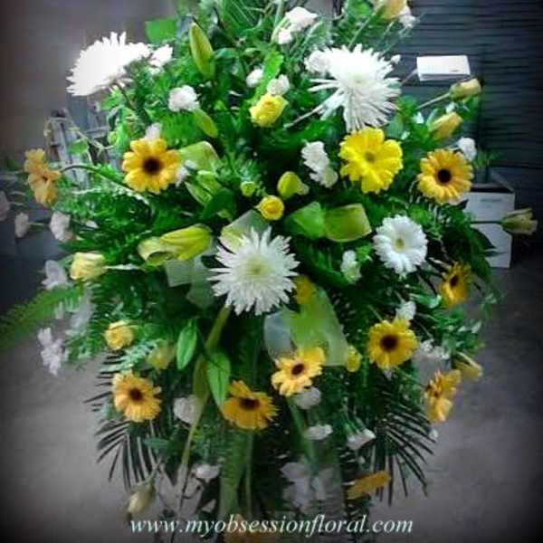 Large standing floral spray with yellow and white daisies