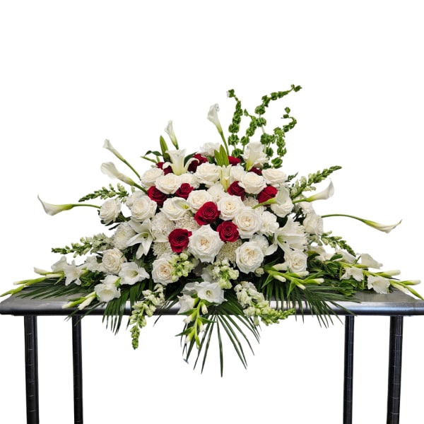 Large white and red floral casket spray with calla lilies and roses